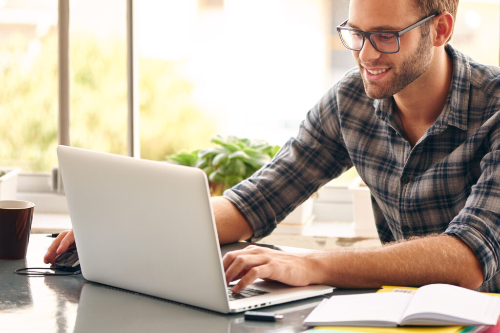 Simple and easy consultant accounting happy man sitting and working at his desk from home